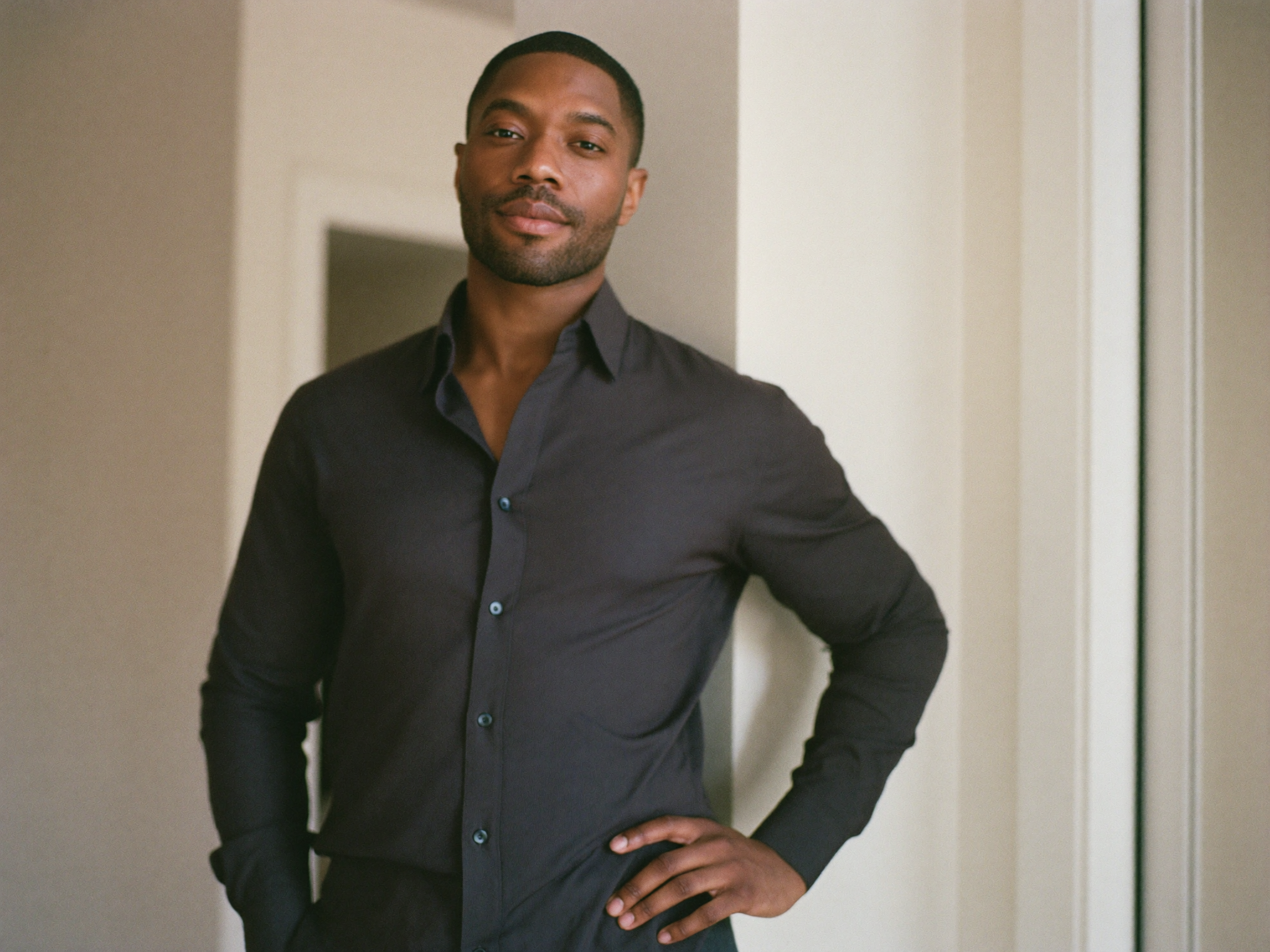 A confident, relaxed man at ease in a bright modern space