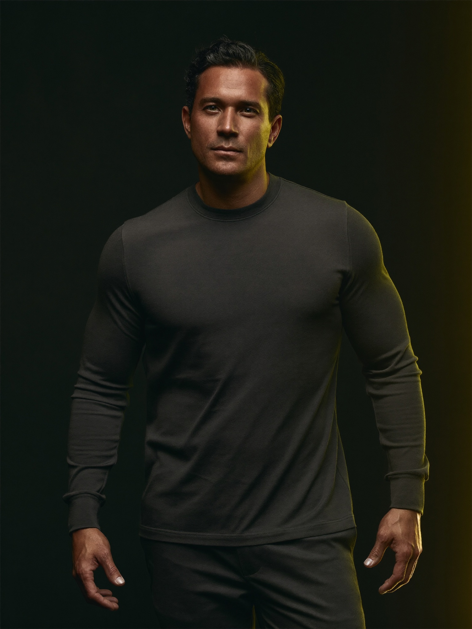 A confident, self-possessed man standing tall, calm and in control