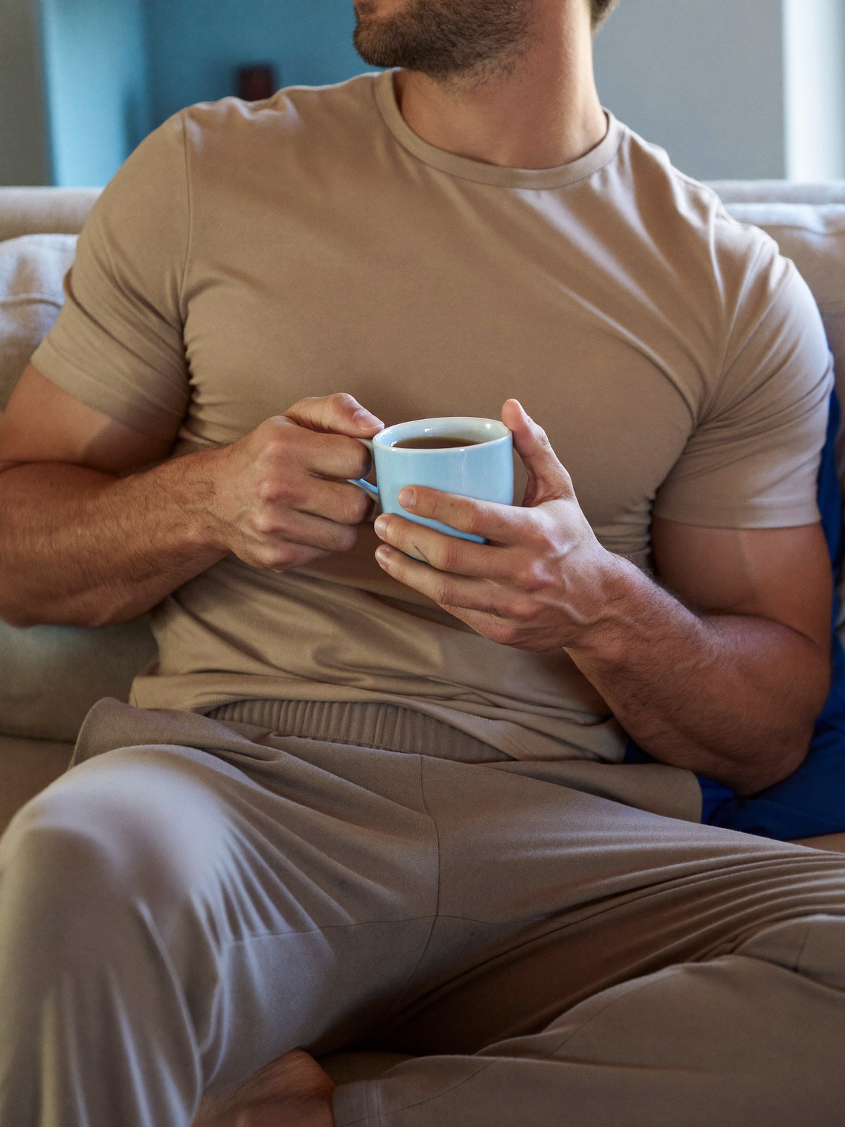 A calm man resting comfortably at home during a light recovery, fully dressed