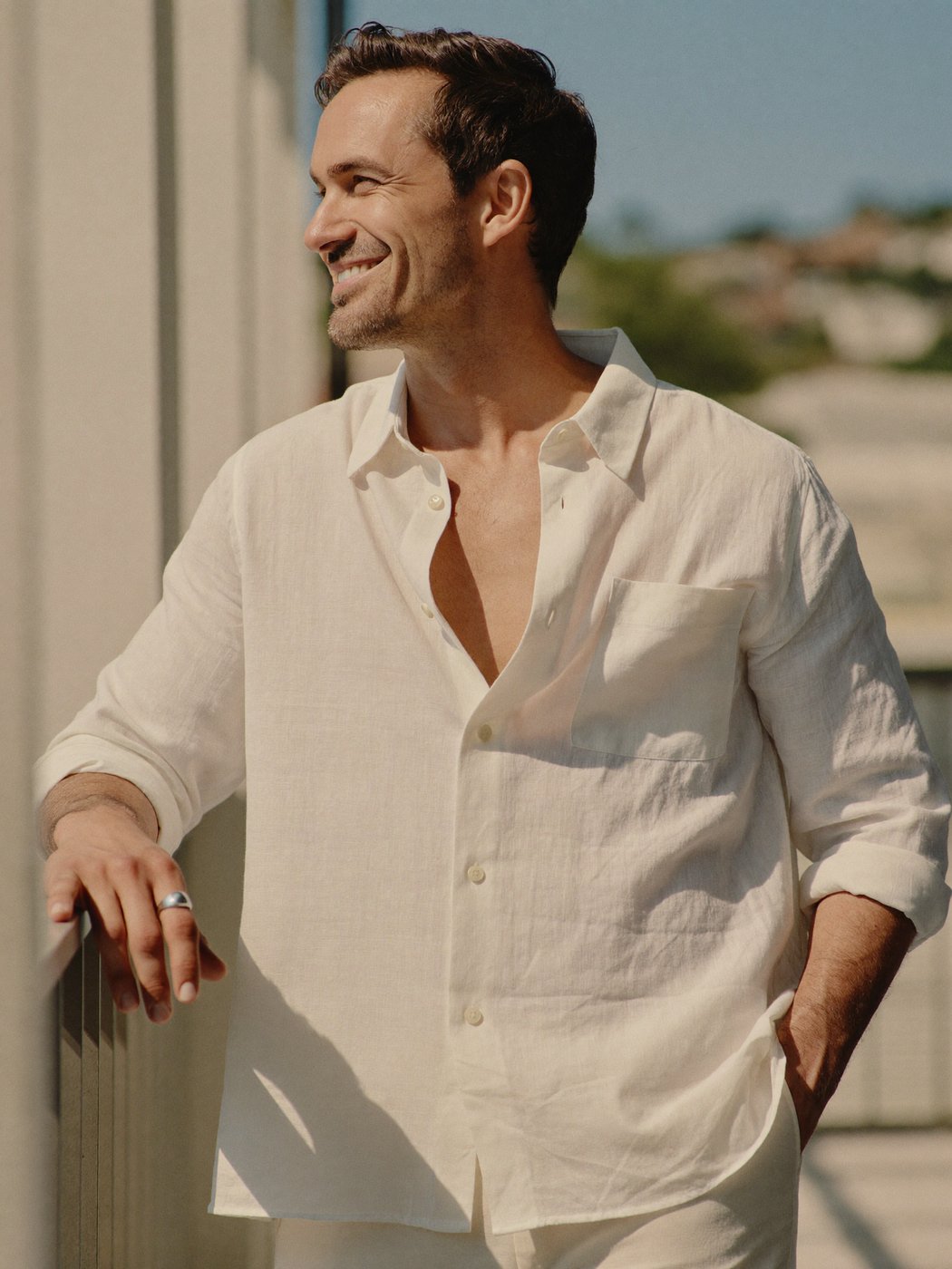 A relaxed, confident man at ease in natural light